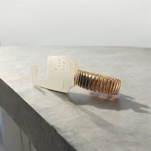 a .new day gold tone stretch bracelet